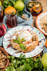 round cake in oriental style with a scoop of ice cream.