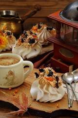 Meringue cake with coffee on a wooden table