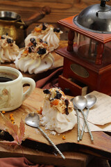 Meringue cake with coffee on a wooden table