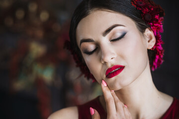 Beautiful gorgeous brunette woman posing in luxury barocco interior in red evening dress