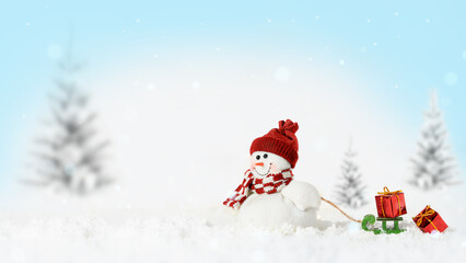 Smiling snowman with sled and gifts on snowy Chistmas background. Copy space