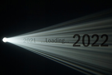 Light beam from spotlight or projector texture and black  background with 2021 loading 2022 word -...