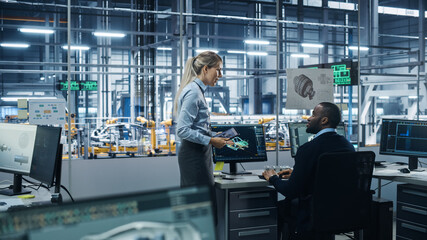 Car Factory Office: Female Supervisor Talks with Male Automotive Engineer, Using Computer to Design Advanced 3D Models for High-Tech Engines. Automated Robot Arm Assembly Line Manufacturing Vehicles