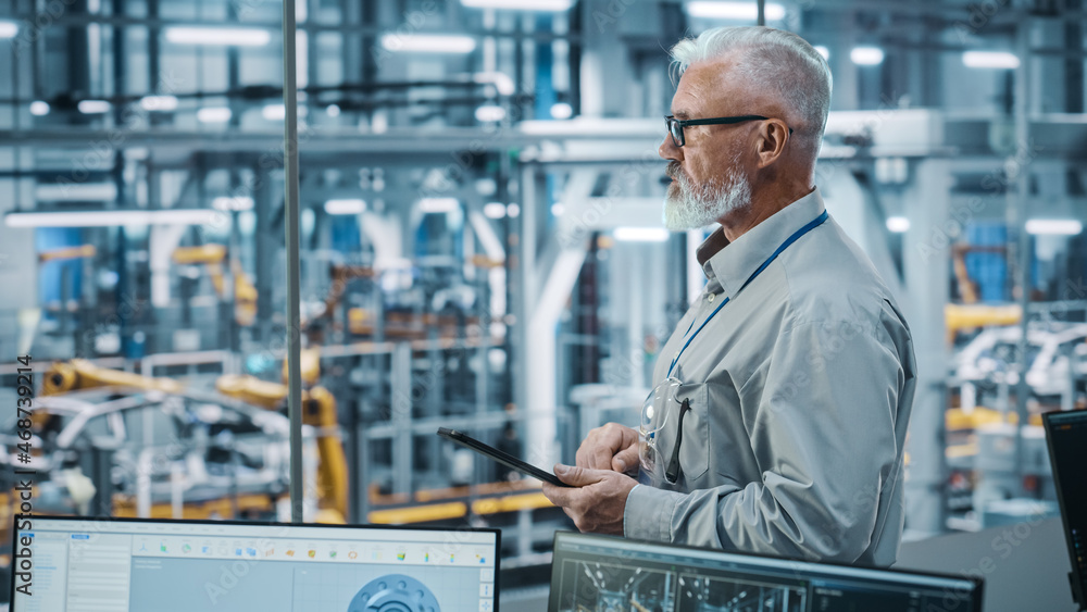 Aufkleber car factory office: portrait of senior white male chief engineer using tablet computer in automated 