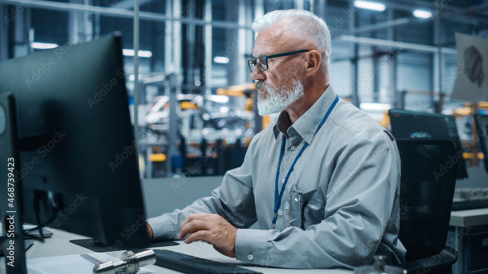 Poster Car Factory Office: Portrait of Male Engineer Working on Computer. Automated Robot Arm Assembly Line Manufacturing Electric Vehicles. Technician Monitoring Electronics Production Conveyor.