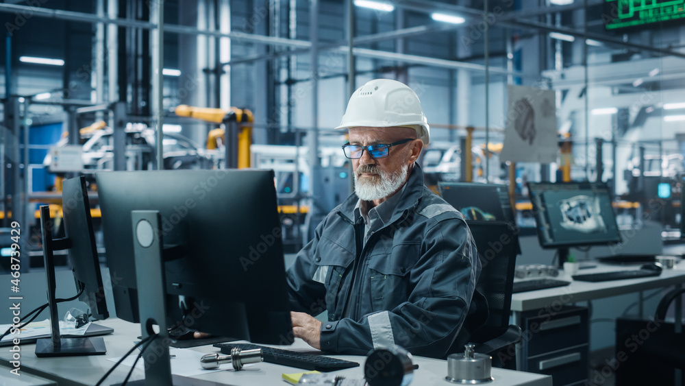 Poster car factory office: portrait of male engineer wearing safety hard hat working on computer. technicia