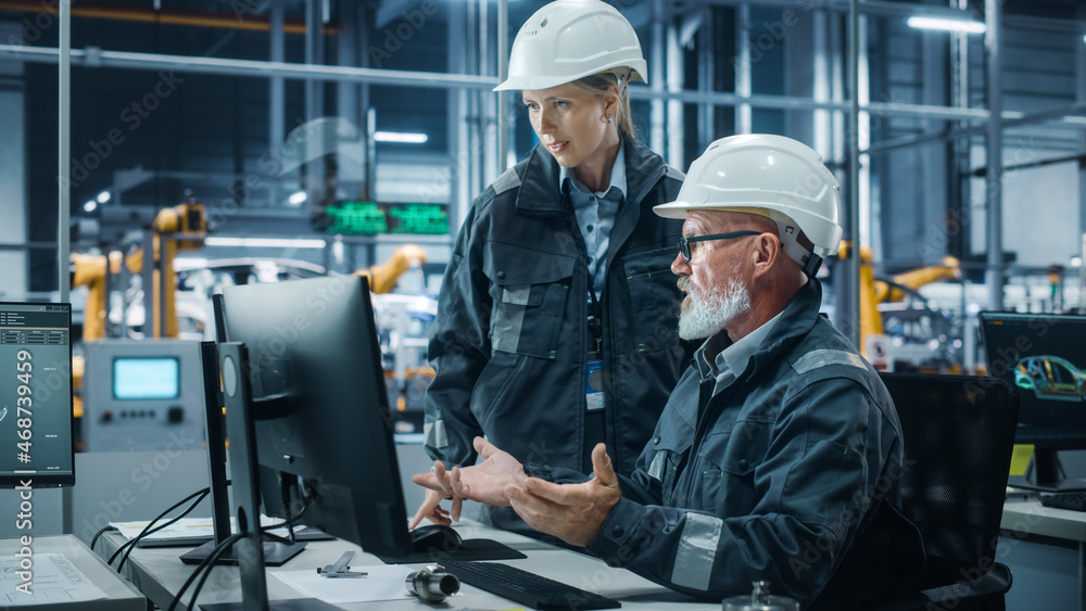 Poster car factory office: female manager talks to male automotive engineer working on computer. automated 