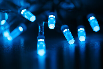 Blue LED light bulbs in a Christmas garland close-up. Holiday goods. Electric Christmas Tree...