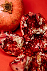 ripe pomegranate on a red background