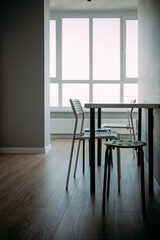 white and black chairs and a white table in a room with gray walls. modern laconic interior.