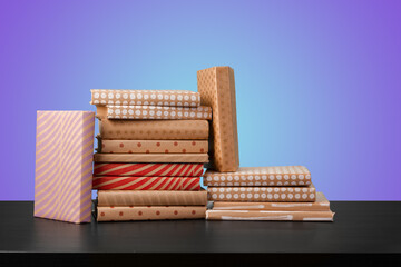 Education concept with stack of books on a table against colored background.