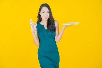 Portrait beautiful young asian woman smile with empty plate dish