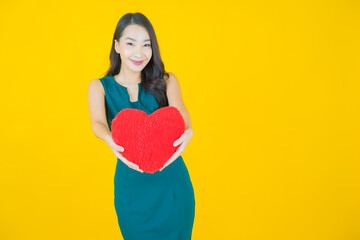 Portrait beautiful young asian woman smile with heart pillow shape