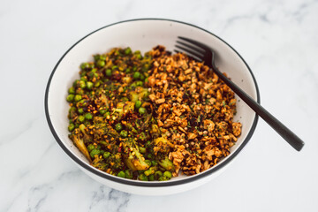 vegan broccoli and peas stiry fry with teriyaki sauce shredded tofu, healthy plant-based food