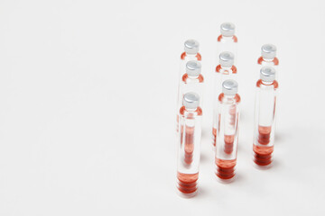 Medical vaccine ampoules on white background