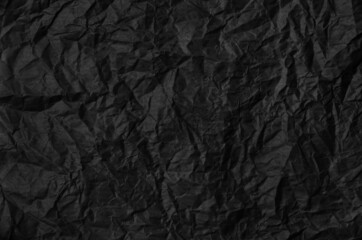 Naklejka premium Crumpled black paper background texture