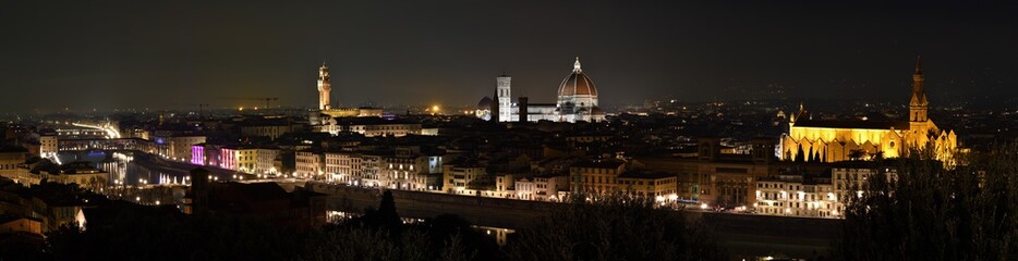 Fototapeta premium Cityscape of Florence at evening with Old Bridge, Palace of Town Hall, Cathedral of Santa Maria del Fiore and Basilica of the Holy Cross illuminated during Christmas period.