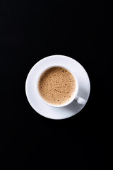 Cup of coffee on black background. Top view. Copy space.	
