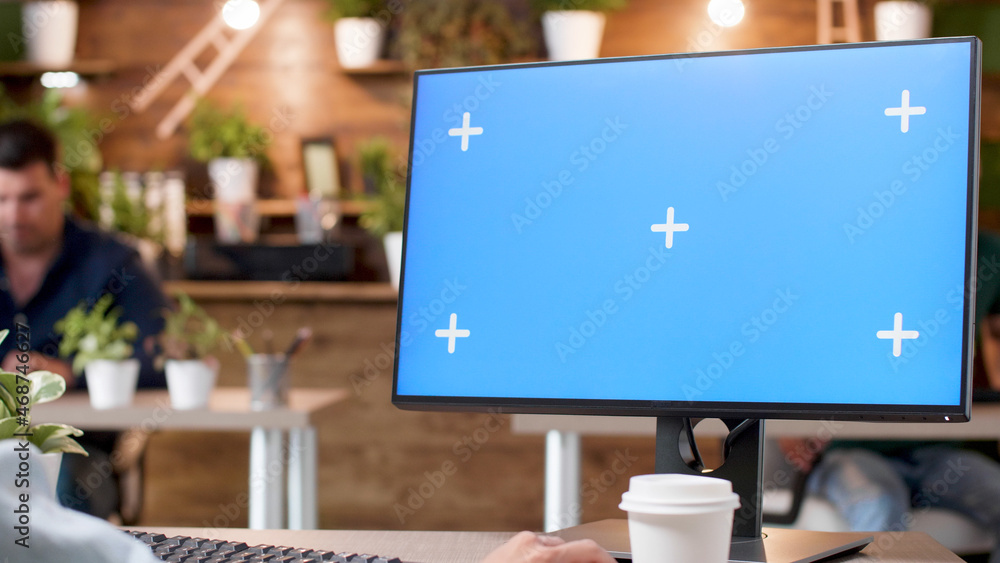 Poster manager looking at mock up green screen chroma key computer with isolated display typing marketing s