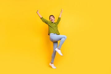 Photo of excited funny dream lady dance look empty space wear green shirt isolated yellow color background