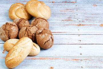 Variety of seeded bread rolls on a blue wood table