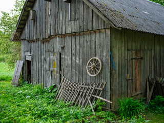 Naklejka premium old countryside barn from wooden planks and concrete in rural area