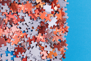 Mixed Peaces of a Colorful Jigsaw Puzzle Lie on the Blue Background - Strategy and Solving Problem Concept