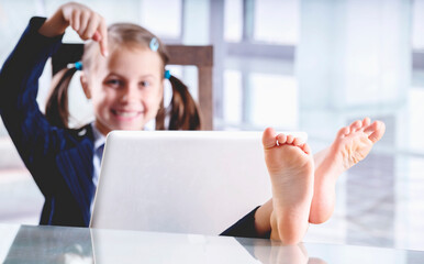 Humorous image of smiling beautiful young business girl working and relaxing in the same time in...