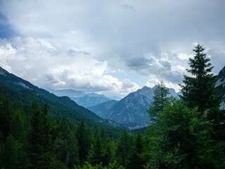 Fototapeta premium summer mountain tops and peaks under blue cloudy sky in Slovenia national Triglav park