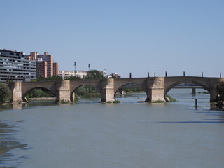 Fototapeta premium Stone bridge of lions and Ebro river in Saragossa city in Spain