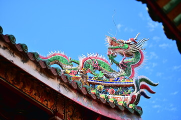 Longshan Temple, Taipei, Taiwan - November 11, 2021: Dragon-shaped Cochin pottery on the eaves of...