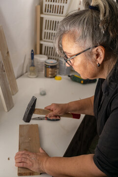 Older Woman Working In Her Workshop