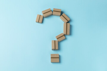 Question mark made from cardboard boxes on a blue background