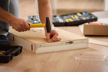 A man assembles a new table with a tools. Handyman