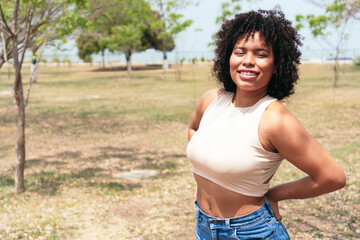 Attractive young woman in the park looking at camera.