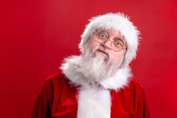 Crazy Santa Claus funny face isolated on red studio background. Fulfillment of desires