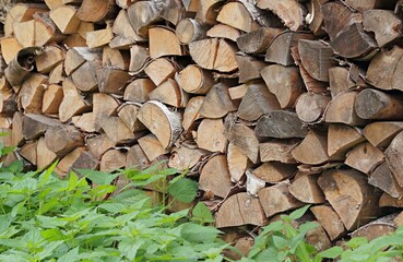 Firewood for the stove. Birch firewood in the yard.