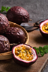 Delicious juicy passion fruit on gray table background.