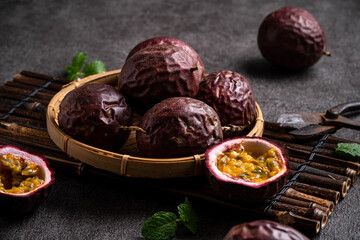 Delicious juicy passion fruit on gray table background.