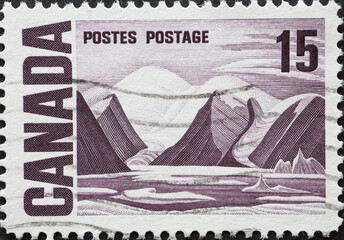 CANADA - CIRCA 1969: A postage stamp from Canada showing a mountain landscape of Bylot Island by...