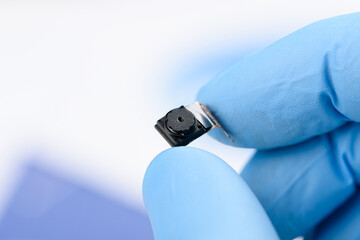 Smartphone camera module in scientist hand