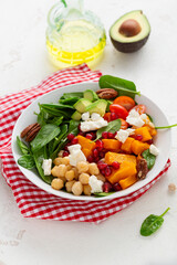 Close up Butternut pumpkin salad with feta and roasted chickpea healthy food bowl avocado