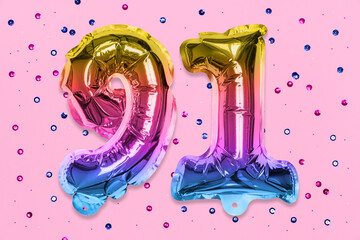 Rainbow foil balloon number, digit ninety one on a pink background with sequins. Birthday greeting card with inscription 91. Top view. Numerical digit. Celebration event, template.