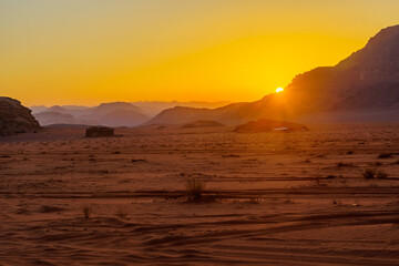 Fototapeta na wymiar Sunset view of a sands and cliffs, in Wadi Rum
