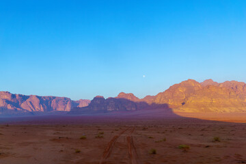 Cliffs and various rock formations, and the moon, Wadi Rum