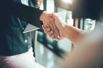 two businessman shake hands as hello in office closeup. Friend welcome, introduction, greet or...