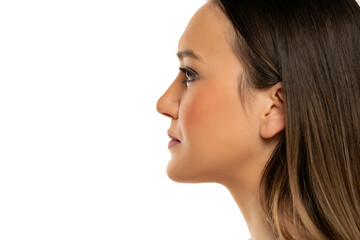 Fototapeta premium Profile of a young beautiful woman with makeup on a white background