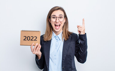 young pretty woman feeling like a happy and excited genius after realizing an idea. calendar concept
