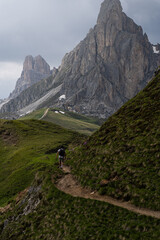Fototapeta na wymiar Man hikes in the Dolomites - Passo Giau