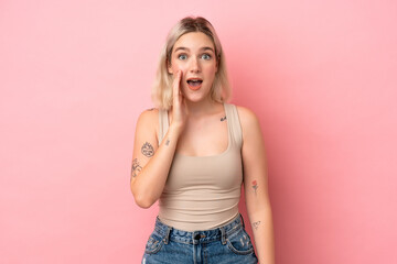 Young caucasian woman isolated on pink background with surprise and shocked facial expression